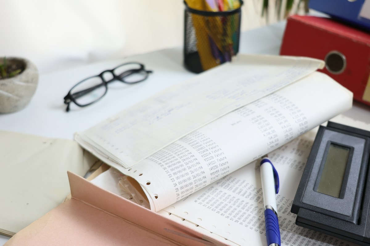 Calculator and organized account paperwork